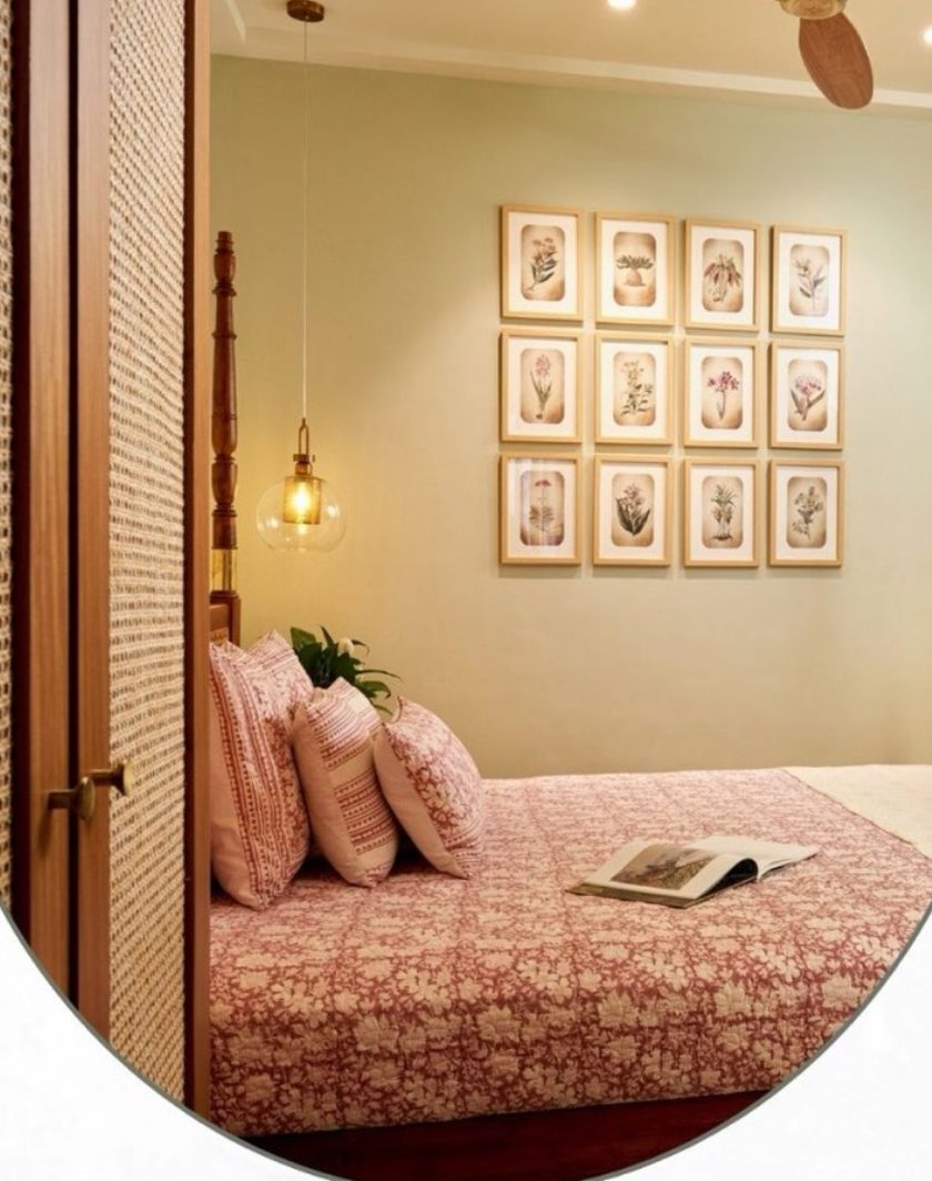 A bedroom with a four-poster bed, a cane-fronted door and a grid of framed botanical prints