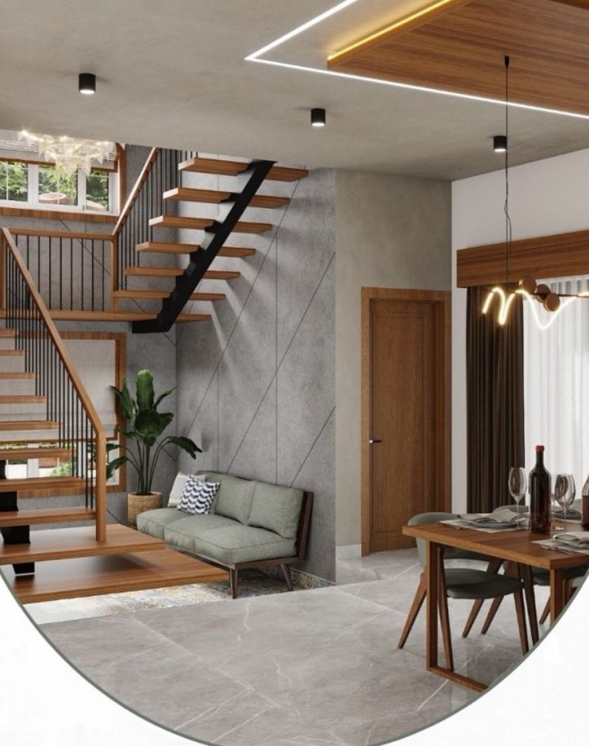 A double-height living space with a floating timber staircase, a grey feature wall and a dining table